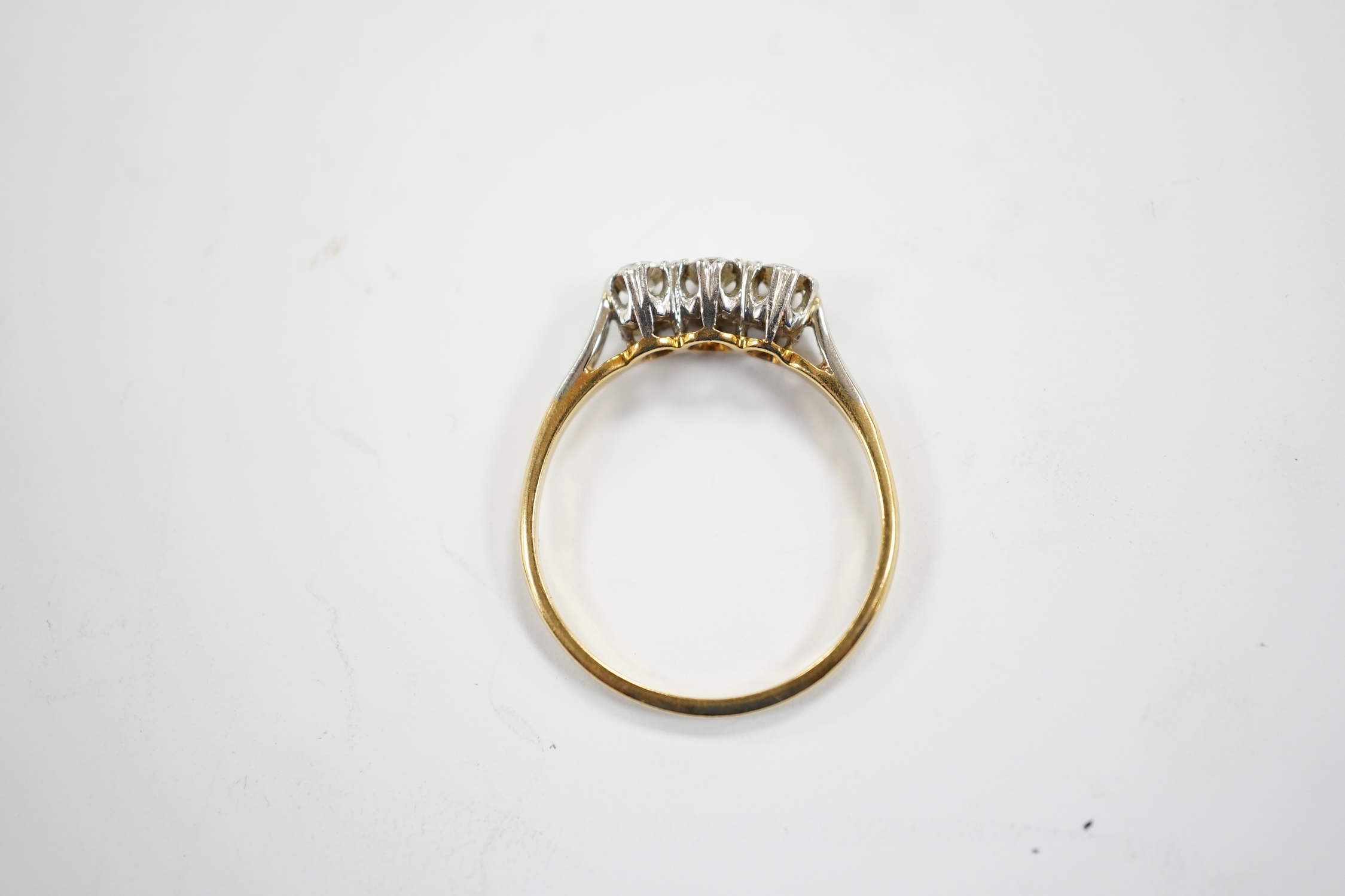 An 18ct, plat and three stone diamond set ring, size P/Q, size 2.6 grams.